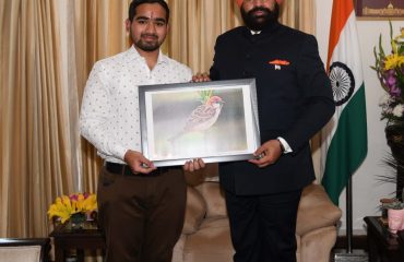 Anurag Ramola presenting a painting of Gauraiya to Governor.
