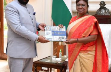 Governor Lt Gen Gurmit Singh (Retd) presents a coffee table book to the Hon'ble President Smt Draupadi Murmu.
