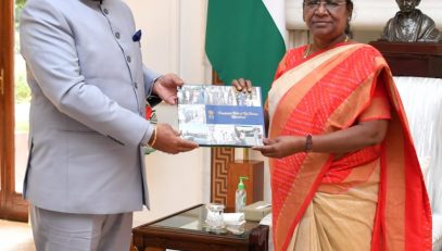 Governor Lt Gen Gurmit Singh (Retd) presents a coffee table book to the Hon'ble President Smt Draupadi Murmu.