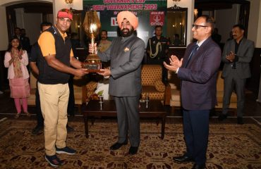 Governor presenting the trophy to Dinesh Panwar, the overall winner/champion of the 18th Governors Cup Golf Tournament.
