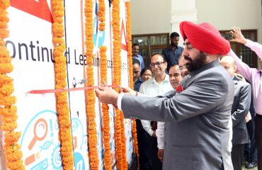 Governor Lt Gen Gurmit Singh (Retd) inaugurates the mobile e-learning vehicle by cutting the ribbon.