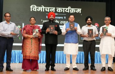 Governor Lt Gen Gurmit Singh (Retd) and Chief Minister Pushkar Singh Dhami release the book 'Atma Ke Swar' at Raj Bhawan.