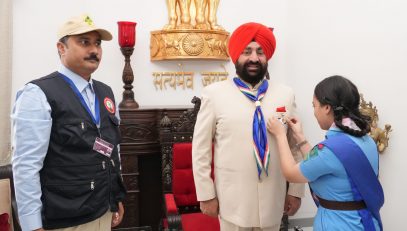 Delegation of Bharat Scouts and Guides wearing the official scarf and flag sticker with Governor Lt Gen Gurmit Singh (Retd).