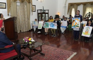 The Governor observes the paintings made by children in the state level painting competition organized by Uttarakhand State Child Welfare Council.
