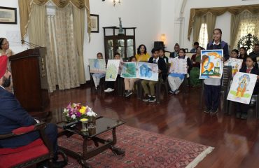 The Governor observes the paintings made by children in the state level painting competition organized by Uttarakhand State Child Welfare Council.