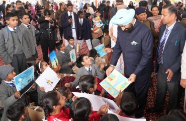 Governor looking at the paintings made by the children of different schools who had come to participate in the painting competition.