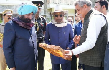 Former President and Governor observing honey processing.