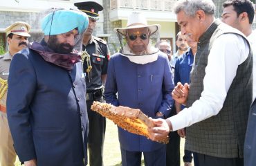 Former President and Governor observing honey processing.