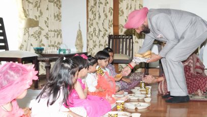 Governor worshiping the girls embodying the goddess along with their family on the occasion of Durga Ashtami of Chaitra Navratri.