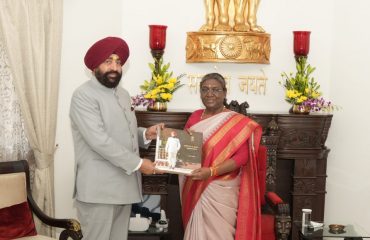 The Governor presenting a coffee table book to Hon'ble President.