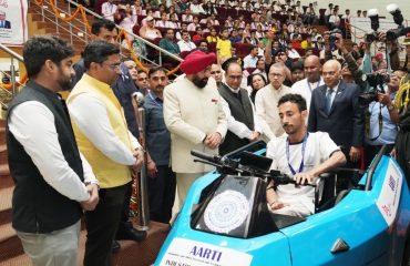 Governor unveiling the electric vehicle designed specifically for the differently abled under the auspices of IIT Roorkee.