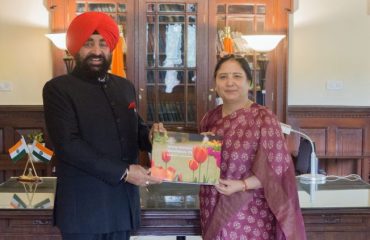 Prof. Surekha Dangwal, VC of Doon University, Dehradun, presenting a coffee table book to the Governor.