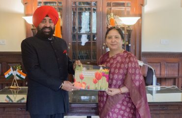 Prof. Surekha Dangwal, VC of Doon University, Dehradun, presenting a coffee table book to the Governor.