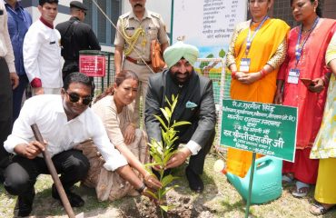 Hon'ble Governor planting a Rudraksh plant.