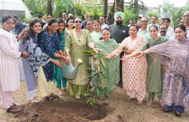Hon'ble Governor, along with officials and staff of Raj Bhawan, planting a sapling alongside the First Lady, Smt. Gurmeet Kaur.