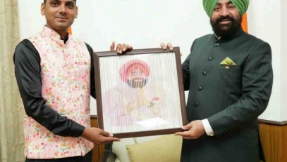 A young artist from Laksar, Haridwar, Mahir presenting a painting to the Hon'ble Governor.