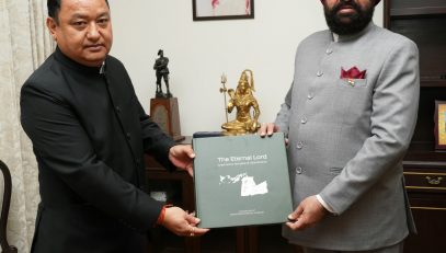 Dhiraj Singh Garbyal, DM Haridwar pays a courtesy visit on the Governor and presents a coffee table book titled, 'The Eternal Lord-Great Shiva Temples of Uttarakhand'.