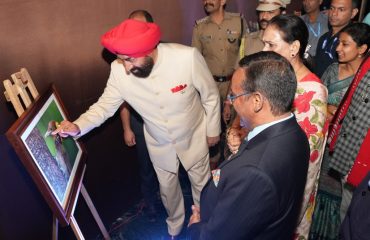 Governor admiring the photographs of birds at an event organized in Mussoorie.