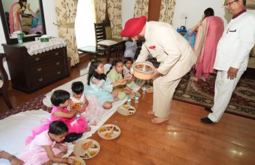 Governor serving prasad girls after Kanya Pujan on Mahanavami of Sharadiya Navratri.