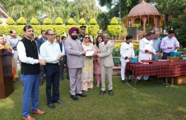 The Governor presenting gifts to the Raj Bhawan employees.