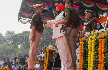 Governor honoring the police officer with 'Police Medal' in the program organized at Police Line, Dehradun on the occasion of State Foundation Day.