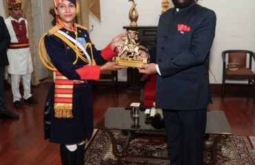 Governor felicitating the parade commanders who led the parade on State Foundation Day.