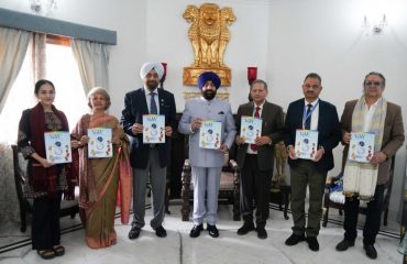 Governor releasing Valley of Words souvenir 'VoWels' at Raj Bhawan.