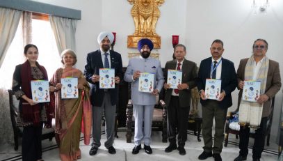 Governor releasing Valley of Words souvenir 'VoWels' at Raj Bhawan.