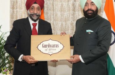 Author Shri BPS Walia presenting his book “Gurudwara of Africa” to the Governor.