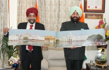 Author Shri BPS Walia presenting his book “Gurudwara of Africa” to the Governor.