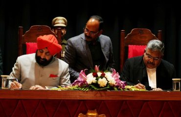 Governor administering the oath of office to the newly appointed Chief Justice of Uttarakhand High Court Justice Guhanathan Narendar.