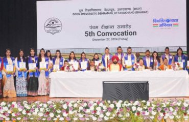 ⁠Governor with students receiving degrees and medals.