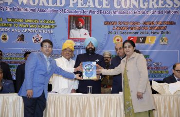 Governor releasing the book “United for Peace: A Shared Vision for Humanity” at the Maha Sammelan.