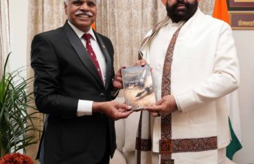 Padma Shri Dr. BKS Sanjay presenting his self-written book 'From the Pain of Surgeons' to the Governor.