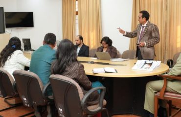 Vice Chancellor of Sridev Suman Uttarakhand University Prof. N.K. Joshi giving a presentation on the progress of research work under the 