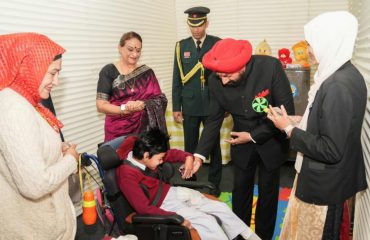 Governor meeting children during the visit to 'Golden Key Asha School'.