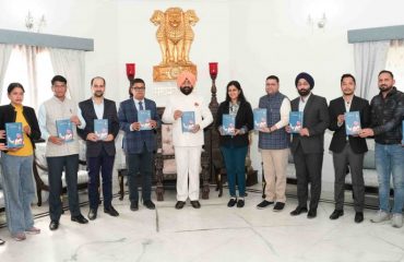 The Governor releasing the book 'Atma Ke Swar' Volume-3 at Raj Bhawan.