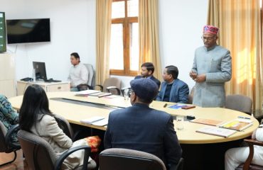 Uttarakhand Sanskrit University Vice Chancellor Prof. Dinesh Chandra Shastri giving a presentation on the progress of research work under 'One University-One Research' before the Governor.