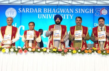 Governor releasing the Annual Report 2023-24 of the University at the first convocation of Sardar Bhagwan Singh University, Dehradun.