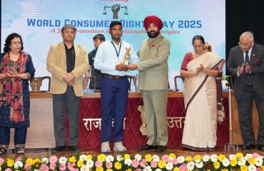 Governor awarding students at a program organized by Bureau of Indian Standards (BIS) on the occasion of World Consumer Rights Day at Raj Bhawan.