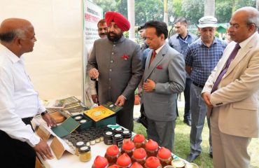 Governor observing the exhibition of beekeeping products in Rajbhawan premises on the occasion of World Bee Day.