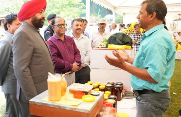 Governor observing the exhibition of beekeeping products in Rajbhawan premises on the occasion of World Bee Day.