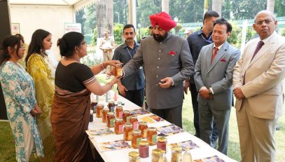 Governor observing the exhibition of beekeeping products in Rajbhawan premises on the occasion of World Bee Day.