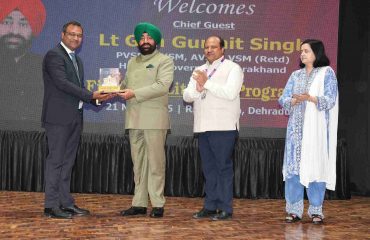 Governor presenting a replica of Shri Badrinath Temple to an officer of State Bank of India.