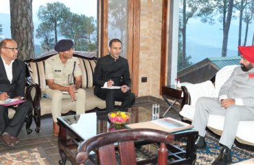 Governor holding a meeting with administrative officials in Kausani.