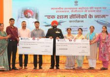 Governor presenting cheques to the family members of soldiers at the program 