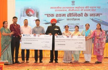 Governor presenting cheques to the family members of soldiers at the program 