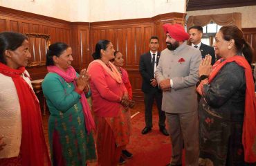 Governor meeting personnel and their families in the Parivar Milan program organized at Raj Bhawan Nainital.