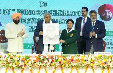 Sherwood College student presenting a sketch to the Vice President.
