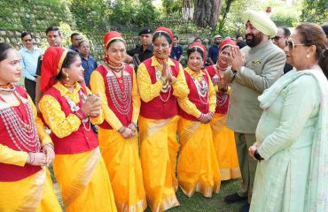 Women in traditional attire performing auspicious songs of Harela with the Governor on the occasion of Harela festival.